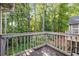 Balcony with wood railings provides a relaxing outdoor space with a view of a verdant forest at 2703 Country Park Dr, Smyrna, GA 30080