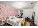 Bright bedroom featuring a large bed, unique wallpaper, workout equipment, and modern lighting for a tranquil space at 2703 Country Park Dr, Smyrna, GA 30080