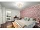 Bedroom features a striking accent wall and a decorative light fixture, creating a cozy and inviting space at 2703 Country Park Dr, Smyrna, GA 30080