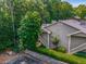 View of condominiums with professional landscaping featuring greenery, trees and a stone retaining wall at 2703 Country Park Dr, Smyrna, GA 30080