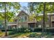 Condominiums with private balconies surrounded by manicured shrubs and mature trees at 2703 Country Park Dr, Smyrna, GA 30080