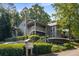 Condominiums with landscaped surroundings, featuring manicured shrubs and mature trees near mailbox at 2703 Country Park Dr, Smyrna, GA 30080
