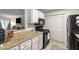 This kitchen boasts granite counters, gas range, modern appliances, storage and easy access to other living spaces at 2703 Country Park Dr, Smyrna, GA 30080