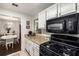 Kitchen area features gas range, granite counters, white cabinets, and access to the dining area for easy entertaining at 2703 Country Park Dr, Smyrna, GA 30080
