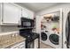 Efficient kitchen includes granite counters, modern appliances, and a laundry area for added convenience at 2703 Country Park Dr, Smyrna, GA 30080