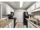 Well-lit kitchen featuring white cabinets, granite countertops, and stainless-steel appliances for a modern touch at 2703 Country Park Dr, Smyrna, GA 30080