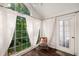 Inviting sunroom with large windows, a cozy chair, hardwood floors and an exterior door at 2703 Country Park Dr, Smyrna, GA 30080