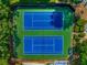 Aerial view of two pristine blue and green tennis courts nestled in a lush, green community at 2703 Country Park Dr, Smyrna, GA 30080
