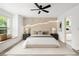 Bright main bedroom with ensuite bath, accent wall, ceiling fan, and large window seat at 32 Wadley Nw St, Atlanta, GA 30314