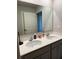Bathroom featuring a double vanity with modern faucets and a large mirror at 4480 Merrigold Way, Fairburn, GA 30213