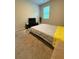Comfortable bedroom featuring a bed with a yellow accent and a mounted TV at 4480 Merrigold Way, Fairburn, GA 30213