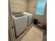 Functional laundry area equipped with a washing machine, dryer, and shelving at 4480 Merrigold Way, Fairburn, GA 30213