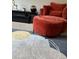 Comfortable living room featuring stylish chair and a decorative modern rug at 4480 Merrigold Way, Fairburn, GA 30213