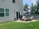 Cozy patio area with outdoor dining set and grill, perfect for entertaining and grilling at 4480 Merrigold Way, Fairburn, GA 30213