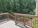 Back deck with brown railings and stairs overlooking trees and grass at 1131 Steeple Run, Lawrenceville, GA 30043