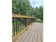 Back deck with brown stained railings overlooking backyard trees and grass at 1131 Steeple Run, Lawrenceville, GA 30043