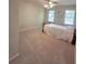 Spacious bedroom with carpeting, a ceiling fan, and natural light from multiple windows at 1131 Steeple Run, Lawrenceville, GA 30043