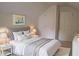 Staged bedroom with gray headboard, white bedding and a modern art print at 1131 Steeple Run, Lawrenceville, GA 30043