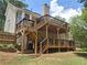Multi-tiered wooden deck offers ample outdoor living space and backyard views on this beautiful home at 1131 Steeple Run, Lawrenceville, GA 30043