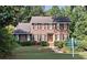 Charming two-story brick home with black shutters and lush green landscaping at 1131 Steeple Run, Lawrenceville, GA 30043
