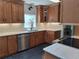 Modern kitchen featuring stainless steel appliances, stone countertops, and wood cabinets at 1131 Steeple Run, Lawrenceville, GA 30043