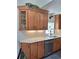 Modern kitchen featuring stainless steel appliances, stone countertops, and wood cabinets at 1131 Steeple Run, Lawrenceville, GA 30043
