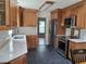 Modern kitchen featuring stainless steel appliances, stone countertops, and wood cabinets at 1131 Steeple Run, Lawrenceville, GA 30043