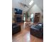 Comfortable living room featuring a vaulted ceiling, fireplace, and modern furniture on gleaming hardwood floors at 1131 Steeple Run, Lawrenceville, GA 30043