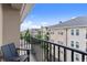 Cozy balcony with a chair overlooking the complex with views of the neighboring buildings and trees at 1850 Cotillion Dr Unit 3416, Atlanta, GA 30338