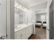 Bathroom showcasing double sink vanity, well-lit mirror, and an open doorway to another room at 1850 Cotillion Dr Unit 3416, Atlanta, GA 30338