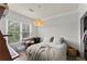 Sunlit bedroom features a comfortable bed, desk, and view of the outdoors at 1850 Cotillion Dr Unit 3416, Atlanta, GA 30338