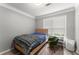 Bedroom featuring a bed, window, and cozy chair; bright and inviting space at 1850 Cotillion Dr Unit 3416, Atlanta, GA 30338