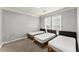Neutral bedroom featuring three twin beds, neutral colored carpet, and bright windows at 1850 Cotillion Dr Unit 3416, Atlanta, GA 30338