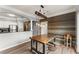 Open concept dining and kitchen area with plank floors, modern lighting, and decorative wood plank accent wall at 1850 Cotillion Dr Unit 3416, Atlanta, GA 30338