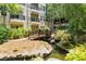 Apartment complex with a bridged stream, greenery, and lush landscaping at 1850 Cotillion Dr Unit 3416, Atlanta, GA 30338