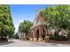 Charming brick apartment building featuring elegant archways, lush landscaping, and a welcoming entrance at 1850 Cotillion Dr Unit 3416, Atlanta, GA 30338