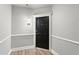 Hallway leading to unit 3416 featuring wood-look floors, clean neutral paint, and classic trim at 1850 Cotillion Dr Unit 3416, Atlanta, GA 30338