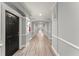 Long hallway with neutral paint, overhead lighting, wood-look floors, and elegant trim details at 1850 Cotillion Dr Unit 3416, Atlanta, GA 30338
