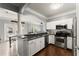 Bright kitchen with stainless steel appliances, granite countertops, and white cabinetry offers an open view to the living room at 1850 Cotillion Dr Unit 3416, Atlanta, GA 30338