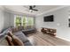 Bright living room with plank floors, large windows, ceiling fan, and comfortable grey sectional couch at 1850 Cotillion Dr Unit 3416, Atlanta, GA 30338
