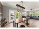 Open concept living room and dining area with plank floors, modern lighting, and a comfortable couch at 1850 Cotillion Dr Unit 3416, Atlanta, GA 30338