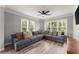 Bright living room with plank floors, large windows, ceiling fan, and comfortable grey sectional couch at 1850 Cotillion Dr Unit 3416, Atlanta, GA 30338