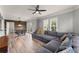 Open concept living room and dining area with plank floors, modern lighting, and a comfortable grey sectional couch at 1850 Cotillion Dr Unit 3416, Atlanta, GA 30338