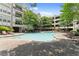 Community pool and seating area with mature trees, creating a refreshing, relaxing atmosphere at 1850 Cotillion Dr Unit 3416, Atlanta, GA 30338