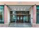 Entrance to Peachtree Towers with stone facade and glass doors with stairs and railings at 300 Peachtree Ne St # 20 O, Atlanta, GA 30308