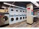 Laundry room with rows of coin-operated washing machines and folding table at 300 Peachtree Ne St # 20 O, Atlanta, GA 30308