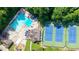 Aerial view of community pool, tennis courts, and playground among mature trees and manicured lawns at 4669 Dunover Cir, Atlanta, GA 30360