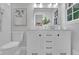 Bright bathroom with white vanity, double sinks, and shower with white tile and modern decor at 4669 Dunover Cir, Atlanta, GA 30360