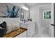 Bathroom with stylish art, white marble countertop, wooden seat and white marble tile flooring at 4669 Dunover Cir, Atlanta, GA 30360