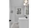 Bathroom featuring gray walls, white vanity, and contemporary lighting fixture at 4669 Dunover Cir, Atlanta, GA 30360